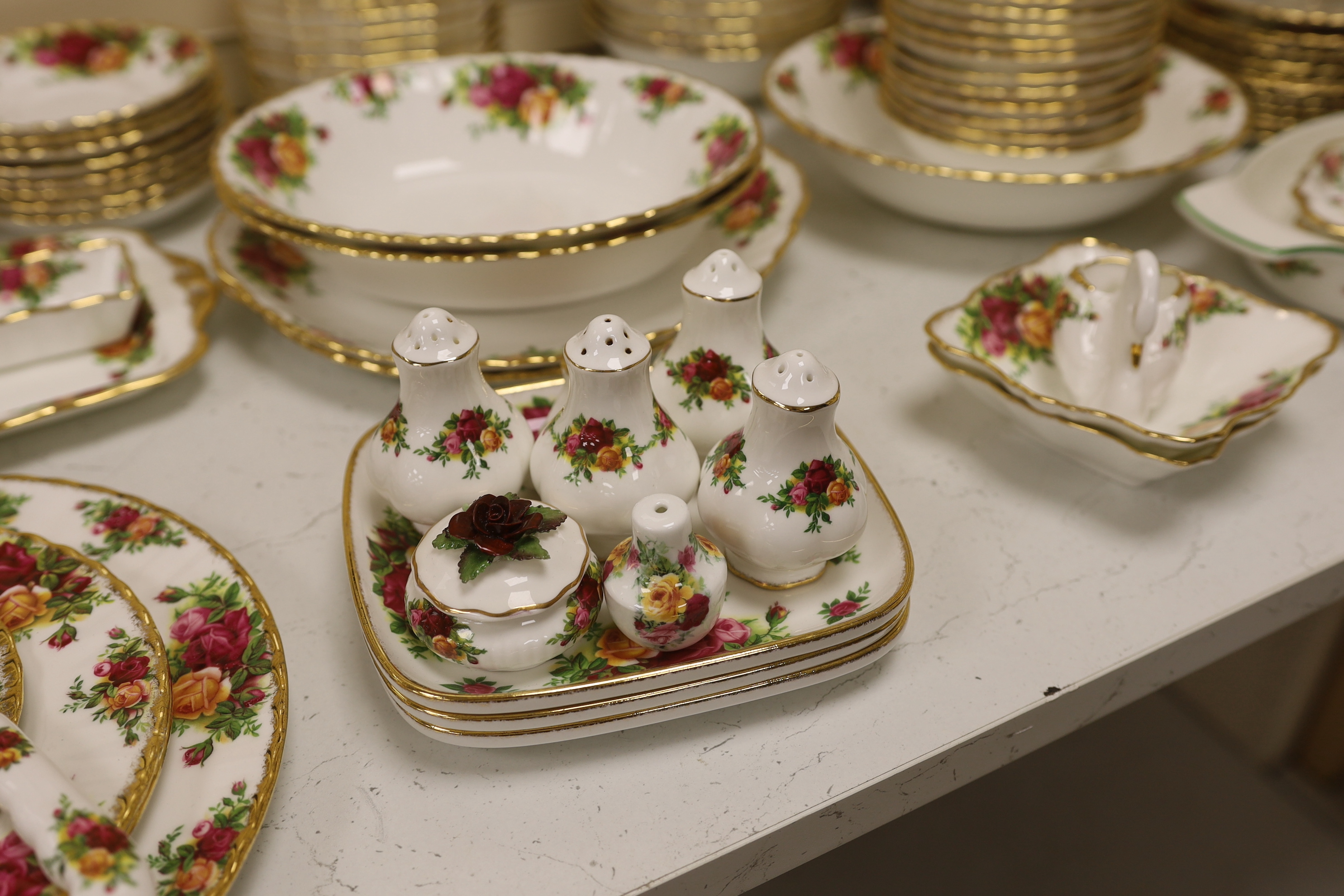 Royal Albert Old Country Roses, a large bone china service for twelve-place setting, and related accessories telephone, wall clock, table mats, napkins and cutlery.